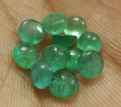 • 5.80 ct Round Cabochon Emeralds.